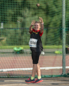 Aoife Grant smiles through her final throw of the 2kg Hammer 